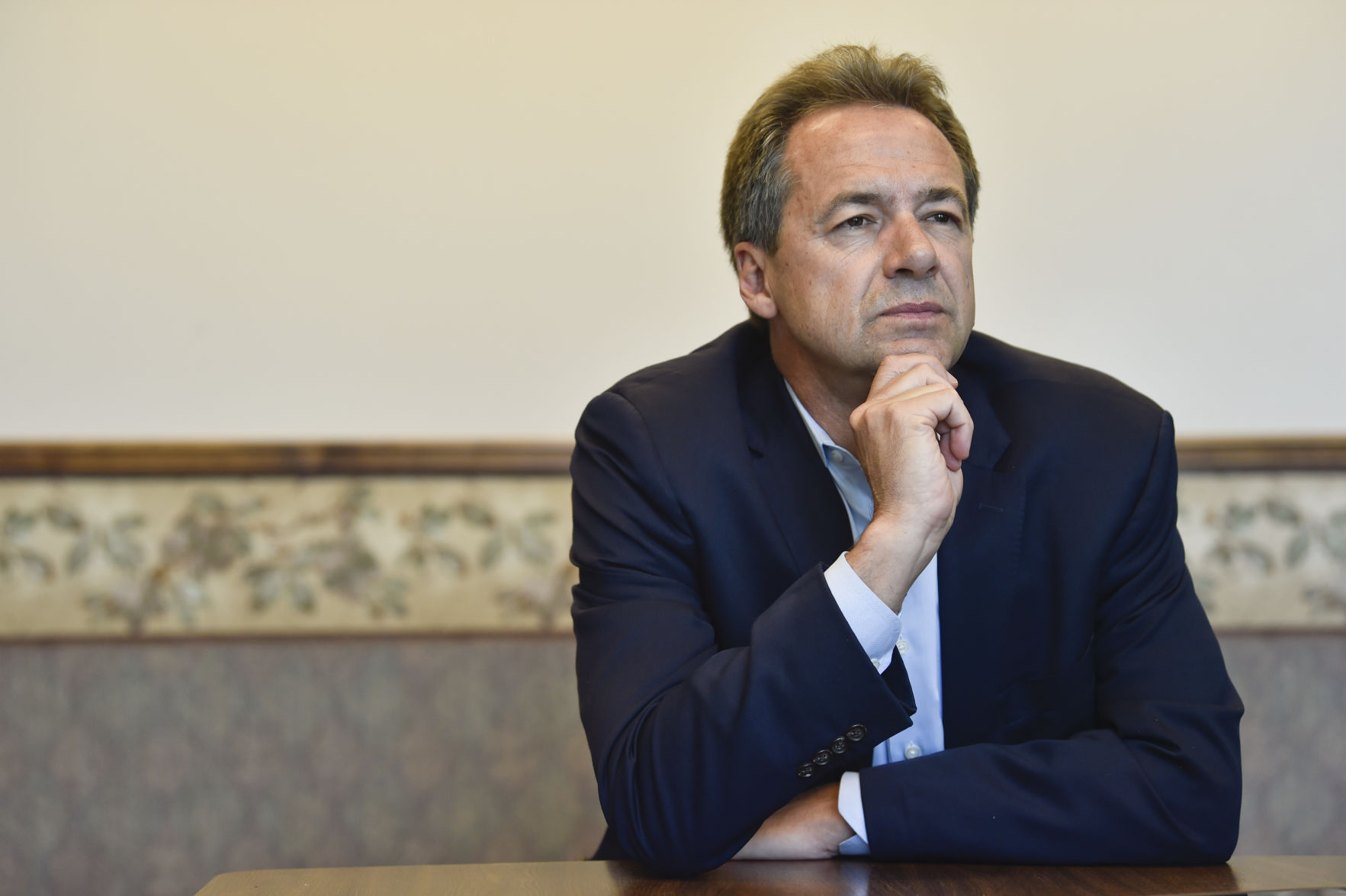 Gov. Steve Bullock talks with a reporter